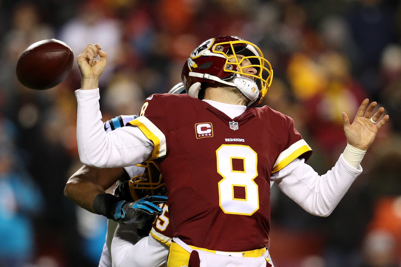 LANDOVER, MD - DECEMBER 19: Quarterback Kirk Cousins #8 of the Washington Redskins fumbles the ball in the third quarter against the Carolina Panthers at FedExField on December 19, 2016 in Landover, Maryland. (Photo by Patrick Smith/Getty Images)