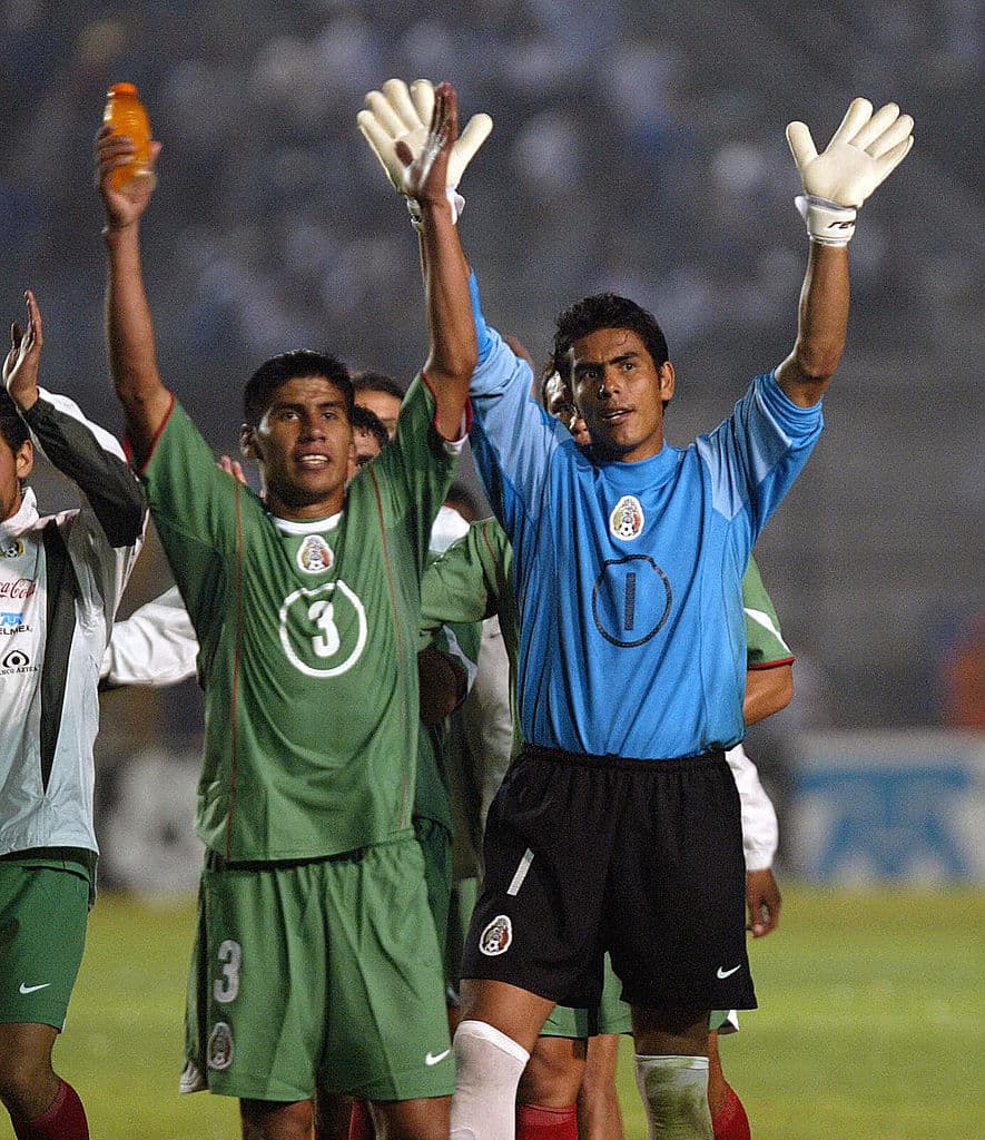 GUATEMALA, GUATEMALA: Mexicans Carlos Salcido (L) and goalkeeper Oswaldo Sanchez (R) celebrate with their supporters at the end of the 2006 World Cup Qualifier game against Guatemala, at the Mateo Flores stadium in Guatemala city, 04 June 2006. Mexico won 2-0. AFP PHOTO/ Orlando SIERRA (Photo credit should read ORLANDO SIERRA/AFP via Getty Images)
