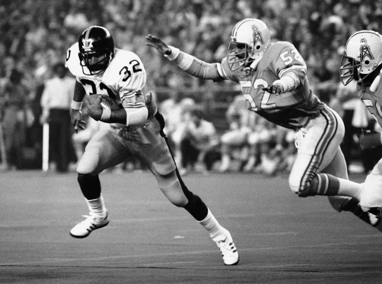 FILE - In this Dec. 3, 1978, file photo, Pittsburgh Steelers running back Franco Harris (32),picks up 10 yards as he turns the corner as Houston Oilers' Robert Brazile (52) makes a dive to latch on to Harris to make the stop, during an NFL football game in Houston. Brazile and Jerry Kramer have been picked as the senior finalists for the 2018 Pro Football Hall of Fame class. The seniors committee selected Brazile and Kramer on Thursday, Aug. 24, 2017. (AP Photo/Ed Kolenovsky, File)