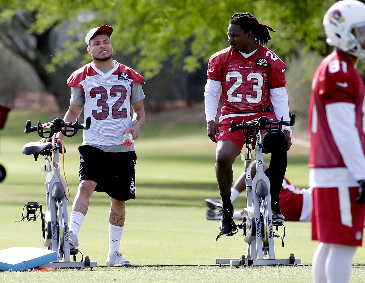 Arizona Cardinals' Tyrann Mathieu (32) talks with Chris Johnson (23) runs drills during a team practice , Tuesday, May 17, 2016, in Tempe, Ariz. (AP Photo/Matt York)