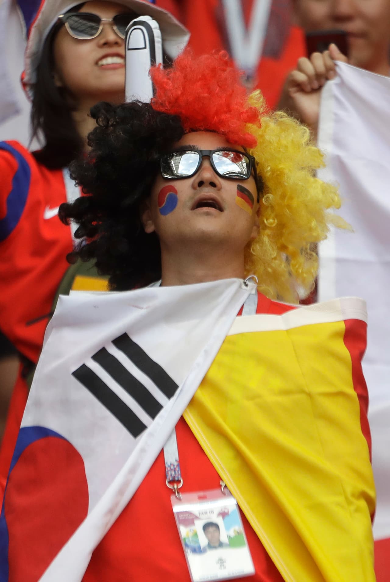 A fan has the colors of Germany and Korea painted onto his face prior to the group F match between South Korea and Germany, at the 2018 soccer World Cup in the Kazan Arena in Kazan, Russia, Wednesday, June 27, 2018. (AP Photo/Michael Probst)