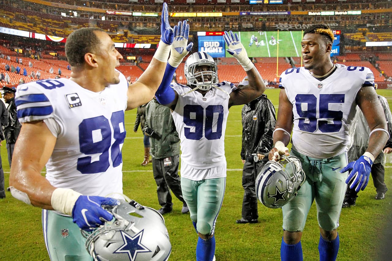 Dallas Cowboys defensive linemen Tyrone Crawford (98), DeMarcus Lawrence (90) and David Irving (95) walk off the field together after a 2017 NFL week 8 regular season game against the Washington Redskins, Sunday, Oct. 29, 2017 in Landover, Md. The Cowboys defeated the Redskins, 33-19. (James D. Smith via AP)