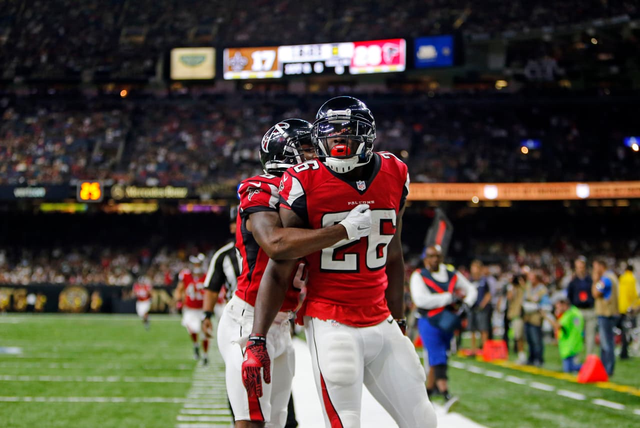Atlanta Falcons running back Tevin Coleman (26) crosses into the end zone for a touchdown in front of New Orleans Saints free safety Vonn Bell (48) in the second half of an NFL football game in New Orleans, Monday, Sept. 26, 2016. (AP Photo/Butch Dill)