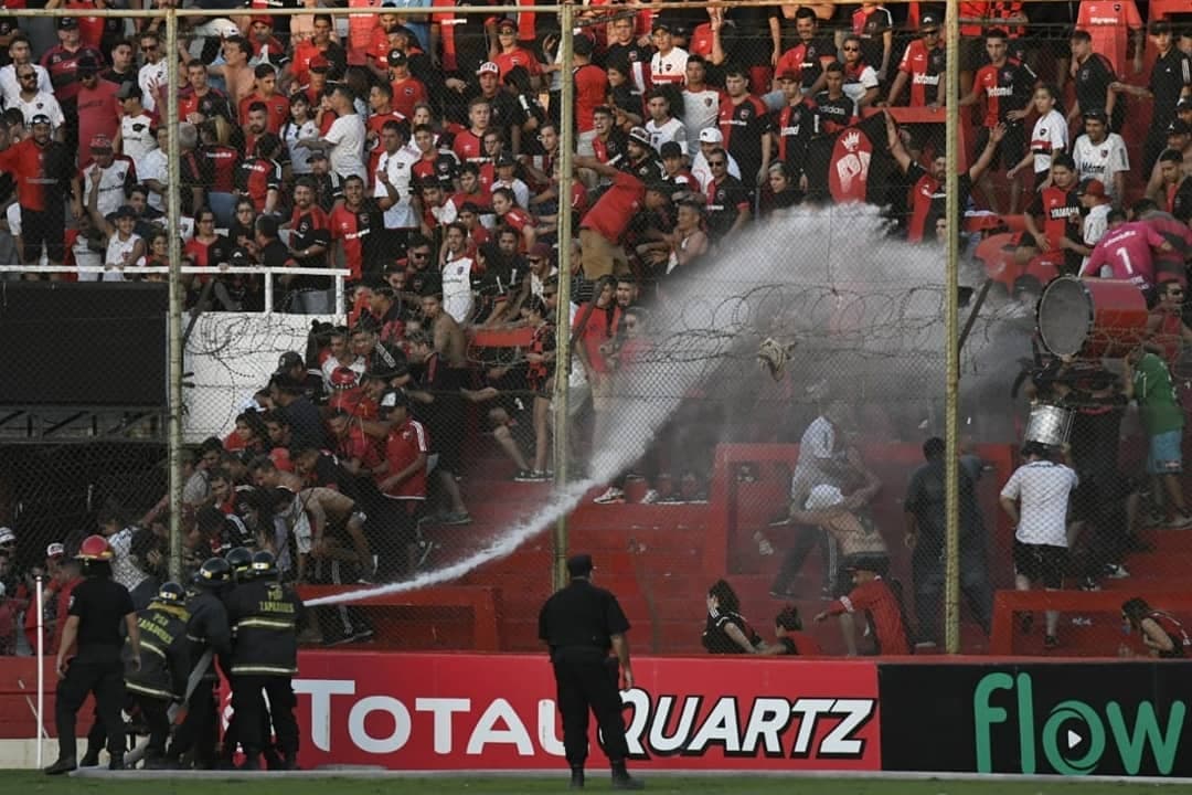 La policía intentó contener con rafagas de agua a los aficionados, que inclusive lanzaron un inodoro por encima de las rejas.