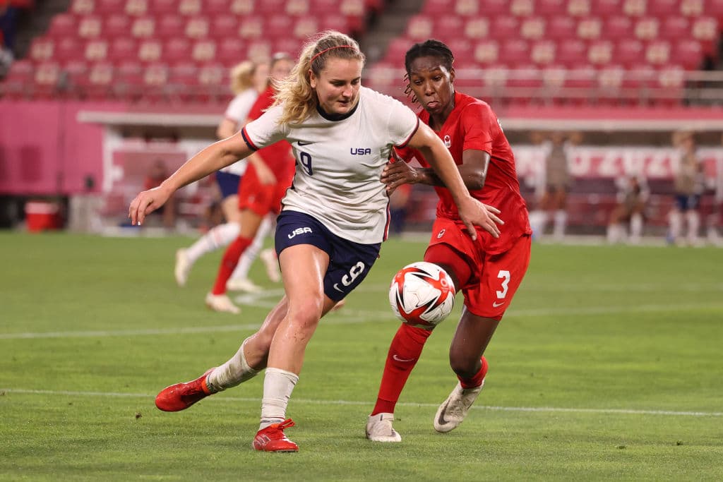 KASHIMA, JAPAN - AUGUST 02: Lindsey Horan #9 of Team United States battles for possession with Kadeisha Buchanan #3 of Team Canada during the Women's Semi-Final match between USA and Canada on day ten of the Tokyo Olympic Games at Kashima Stadium on August 02, 2021 in Kashima, Ibaraki, Japan. (Photo by Atsushi Tomura/Getty Images)