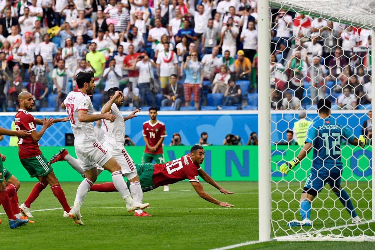 Morocco's forward Aziz Bouhaddouz (C) scores an own goal during the Russia 2018 World Cup Group B football match between Morocco and Iran at the Saint Petersburg Stadium in Saint Petersburg on June 15, 2018. (Photo by CHRISTOPHE SIMON / AFP) / RESTRICTED TO EDITORIAL USE - NO MOBILE PUSH ALERTS/DOWNLOADS (Photo credit should read CHRISTOPHE SIMON/AFP/Getty Images)