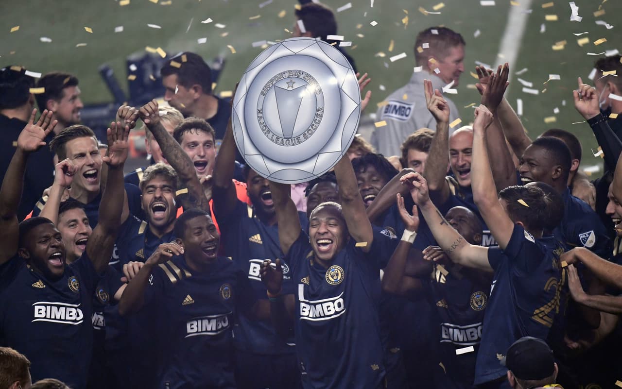 Nov 8, 2020; Chester, Pennsylvania, USA; Philadelphia Union midfielder Jose Andres Martinez (8) holds up the Supporters' Shield after defeating the New England Revolution at Subaru Park. Mandatory Credit: Eric Hartline-USA TODAY Sports