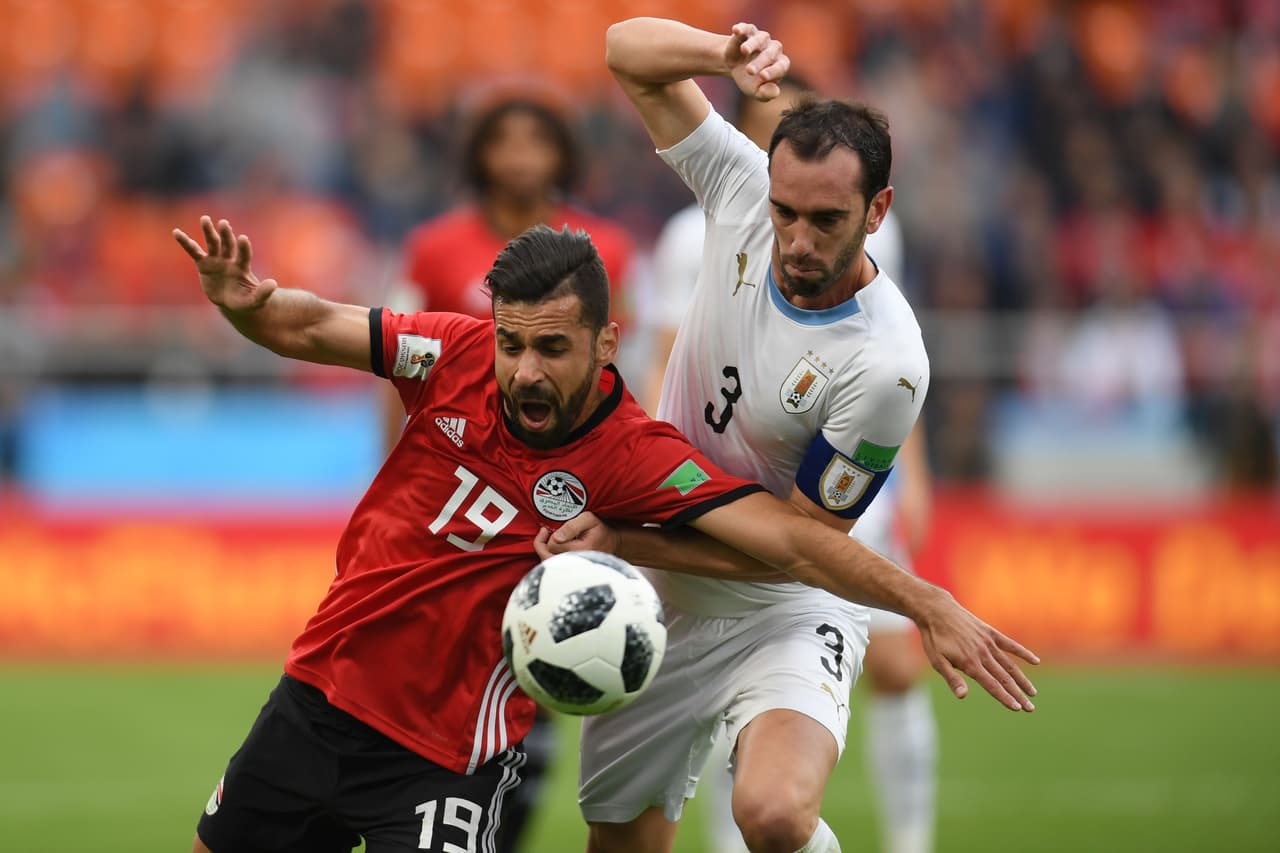 Egypt's forward Marwan Mohsen (L) tangles with Uruguay's defender Diego Godin (R) during the Russia 2018 World Cup Group A football match between Egypt and Uruguay at the Ekaterinburg Arena in Ekaterinburg on June 15, 2018. (Photo by JORGE GUERRERO / AFP) / RESTRICTED TO EDITORIAL USE - NO MOBILE PUSH ALERTS/DOWNLOADS (Photo credit should read JORGE GUERRERO/AFP/Getty Images)