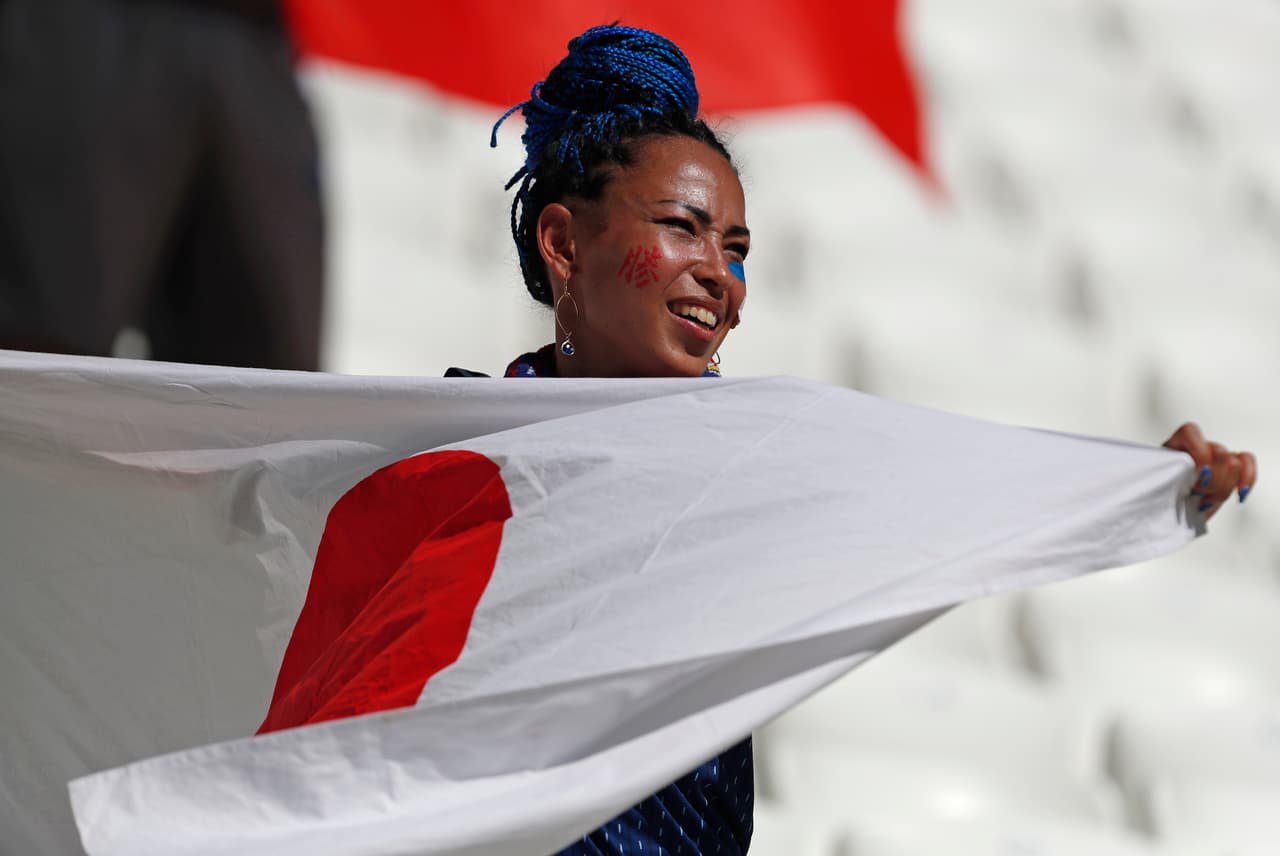 A Japanese supporter holds a Japan flag before the group H match between Japan and Poland at the 2018 soccer World Cup at the Volgograd Arena in Volgograd, Russia, Thursday, June 28, 2018. (AP Photo/Darko Vojinovic)