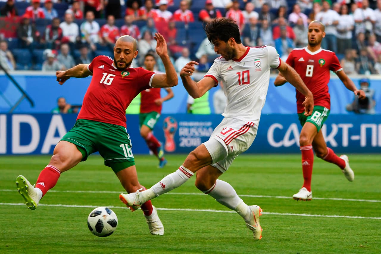 Iran's forward Karim Ansari Fard (R) and Morocco's forward Noureddine Amrabat vie during the Russia 2018 World Cup Group B football match between Morocco and Iran at the Saint Petersburg Stadium in Saint Petersburg on June 15, 2018. (Photo by Paul ELLIS / AFP) / RESTRICTED TO EDITORIAL USE - NO MOBILE PUSH ALERTS/DOWNLOADS (Photo credit should read PAUL ELLIS/AFP/Getty Images)