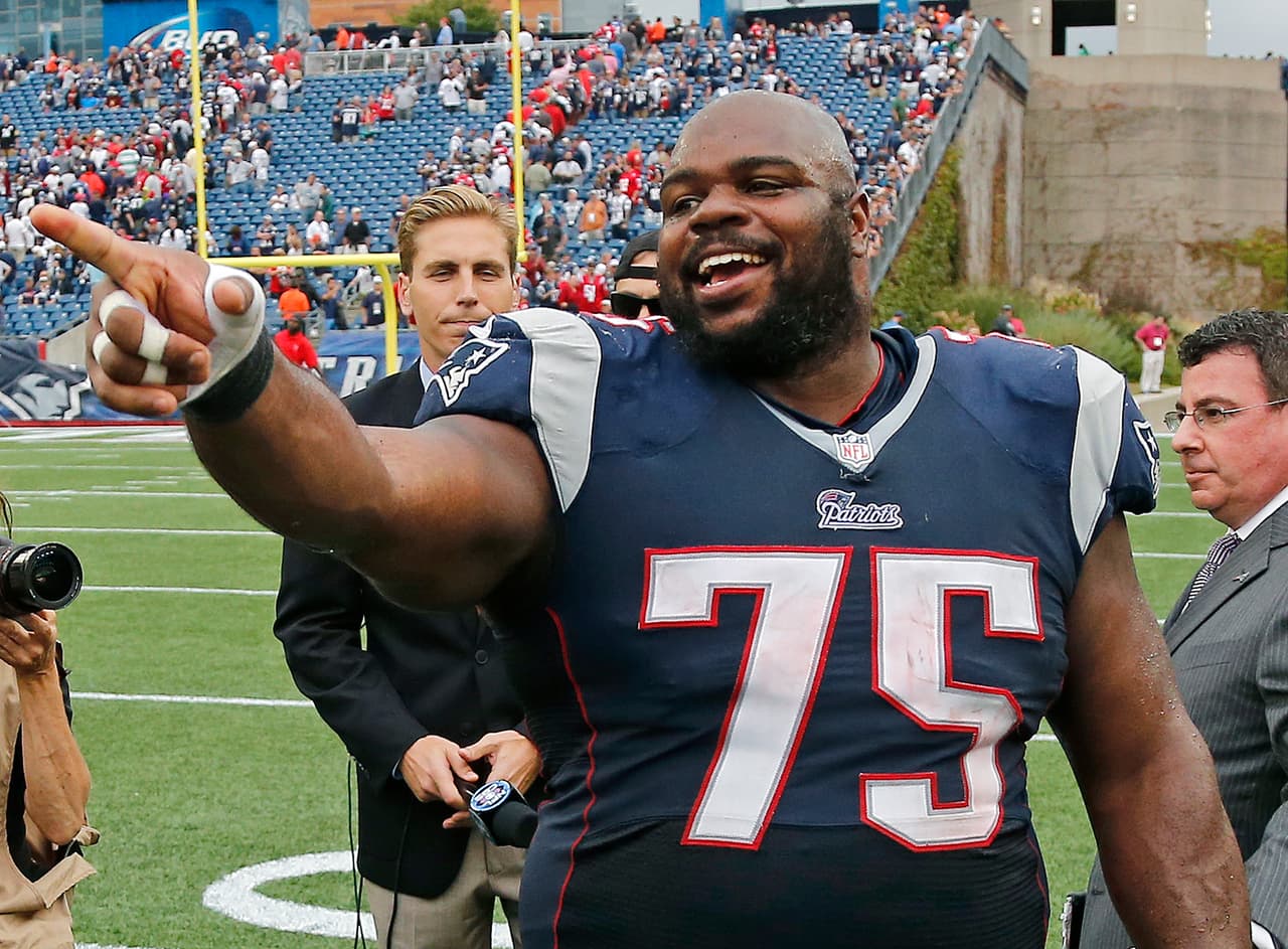 New England Patriots defensive tackle Vince Wilfork (75) smiles and points after an NFL football game against the Oakland Raiders Sunday, Sept. 21, 2014, in Foxborough, Mass. Wilfork intercepted the ball in the last minute of the game. The Patriots won 16-9. (AP Photo/Elise Amendola)