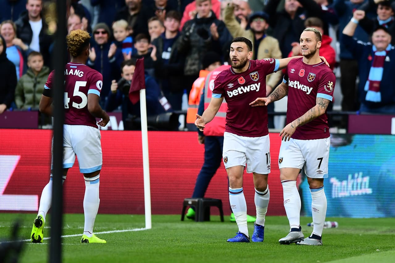 LONDON, ENGLAND - NOVEMBER 03: Marko Arnautovic of West Ham United celebrates after scoring his team's first goal with Robert Snodgrass of West Ham United and Grady Diangana of West Ham United during the Premier League match between West Ham United and Burnley FC at London Stadium on November 3, 2018 in London, United Kingdom. (Photo by Alex Broadway/Getty Images)