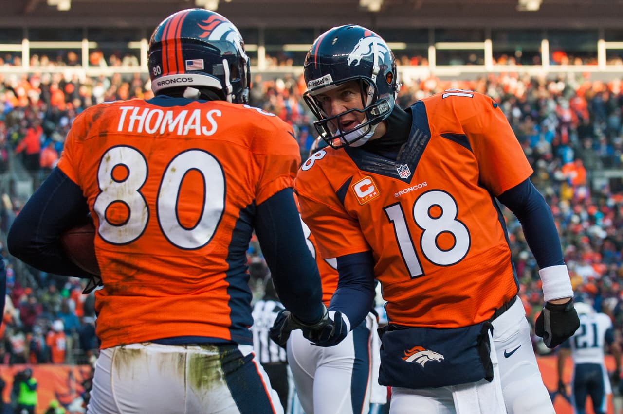 DENVER, CO - DECEMBER 8: Tight end Julius Thomas #80 of the Denver Broncos celebrates a second quarter touchdown against the Tennessee Titans with Peyton Manning #18 at Sports Authority Field Field at Mile High on December 8, 2013 in Denver, Colorado. (Photo by Dustin Bradford/Getty Images)