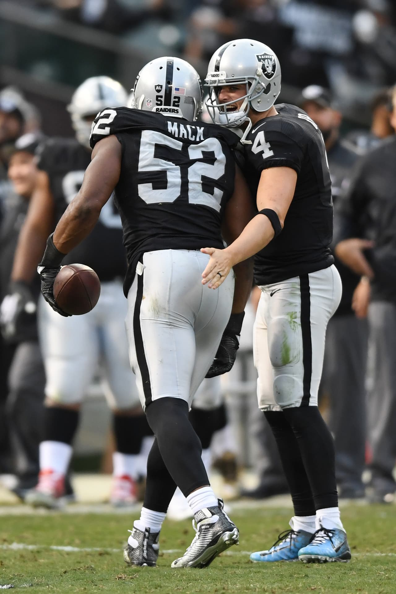 OAKLAND, CA - DECEMBER 04: Khalil Mack #52 of the Oakland Raiders celebrates with Derek Carr #4 after a fumble recovery against the Buffalo Bills during their NFL game at Oakland Alameda Coliseum on December 4, 2016 in Oakland, California. (Photo by Thearon W. Henderson/Getty Images)