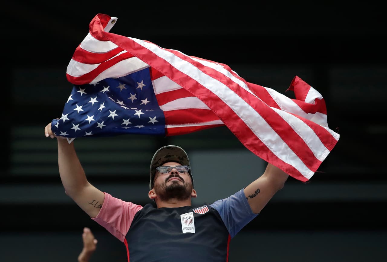 A fan waves a U.S. flag prior to a World Cup qualifying soccer match between the United States and Costa Rica, Friday, Sept. 1, 2017, in Harrison, N.J. (AP Photo/Julio Cortez)