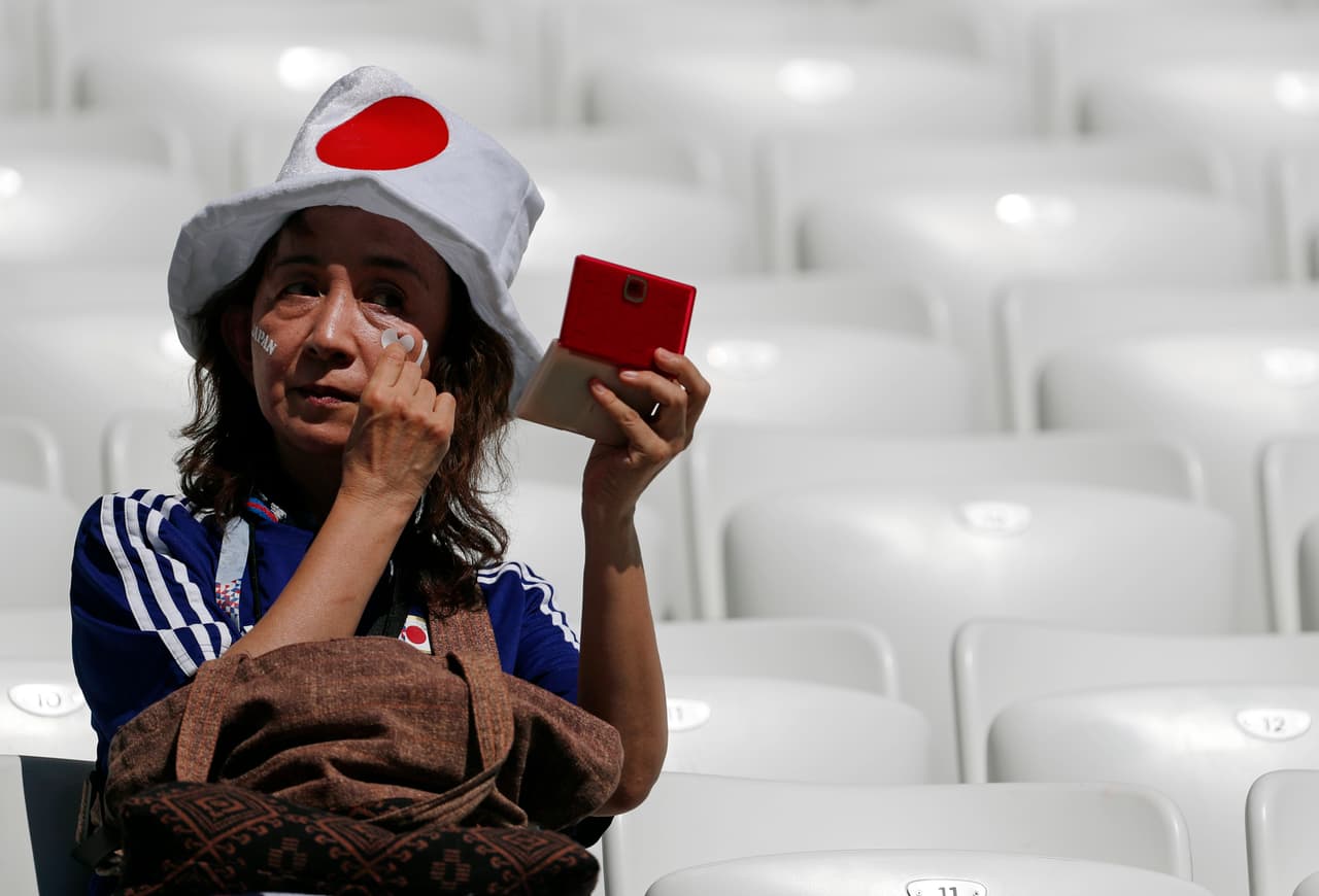 A Japanese supporter applies a transfer to her face before the group H match between Japan and Poland at the 2018 soccer World Cup at the Volgograd Arena in Volgograd, Russia, Thursday, June 28, 2018. (AP Photo/Darko Vojinovic)