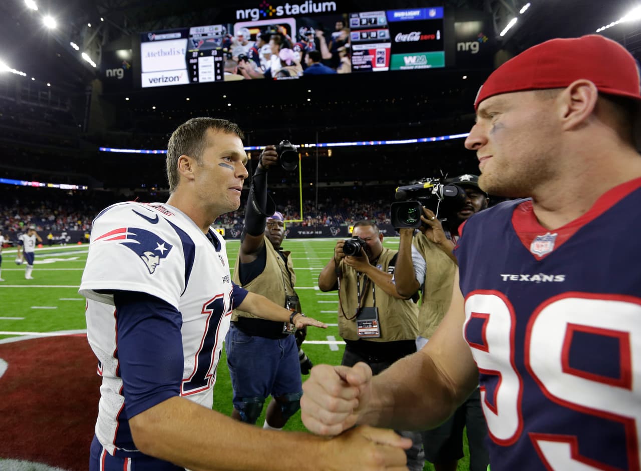 New England Patriots quarterback Tom Brady, left, greets Houston Texans defensive end J.J. Watt, right, following an NFL football preseason game Saturday, Aug. 19, 2017, in Houston. (AP Photo/David J. Phillip)