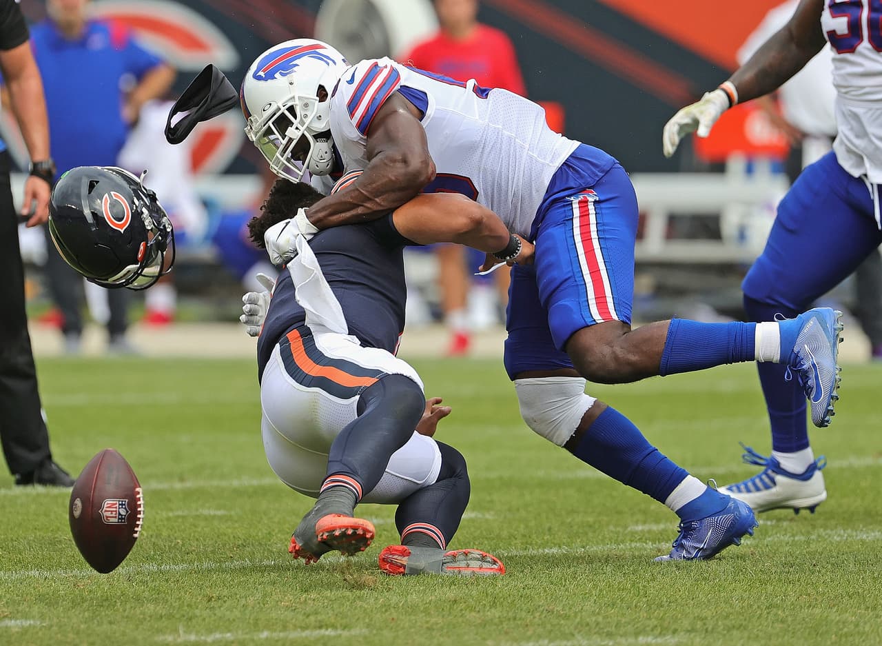 CHICAGO, ILLINOIS - AUGUST 21: Justin Fields #1 of the Chicago Bears is hit by Andre Smith #59 of the Buffalo Bills during a preseason game at Soldier Field on August 21, 2021 in Chicago, Illinois. The Bills defeated the Bears 41-15. (Photo by Jonathan Daniel/Getty Images)