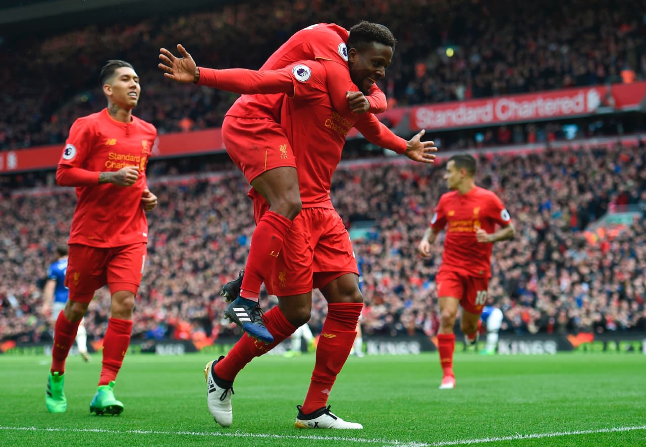 Liverpool's Belgian striker Divock Origi (C) celebrates with teammates after scoring their third goal during the English Premier League football match between Liverpool and Everton at Anfield in Liverpool, north west England on April 1, 2017. / AFP PHOTO / Paul ELLIS / RESTRICTED TO EDITORIAL USE. No use with unauthorized audio, video, data, fixture lists, club/league logos or 'live' services. Online in-match use limited to 75 images, no video emulation. No use in betting, games or single club/league/player publications. / (Photo credit should read PAUL ELLIS/AFP/Getty Images)