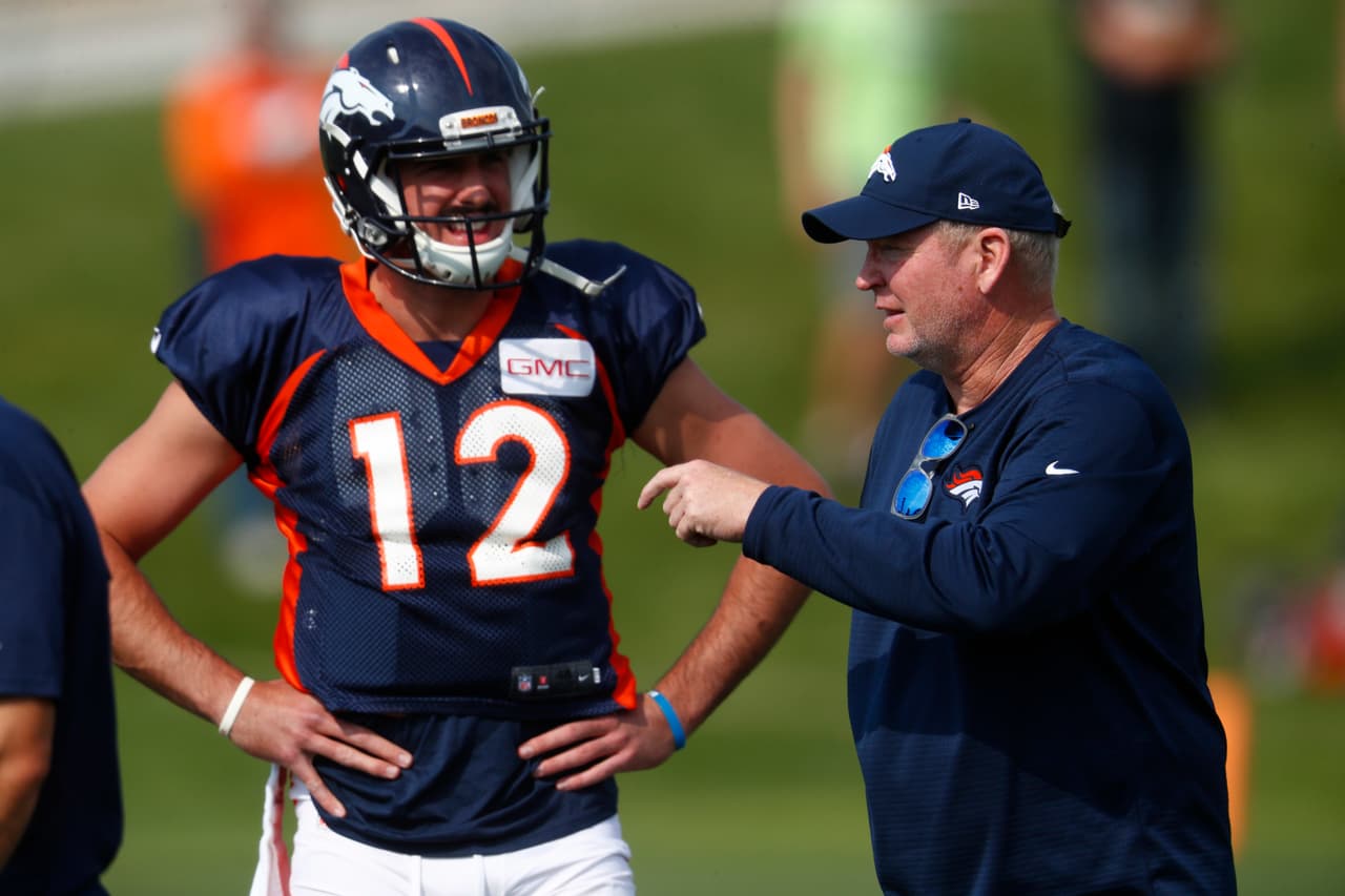 Denver Broncos quarterback coach Bill Musgrave, right, chats with quarterback Paxton Lynch during an NFL football training camp Saturday, Aug. 5, 2017, in Englewood, Colo. (AP Photo/David Zalubowski)