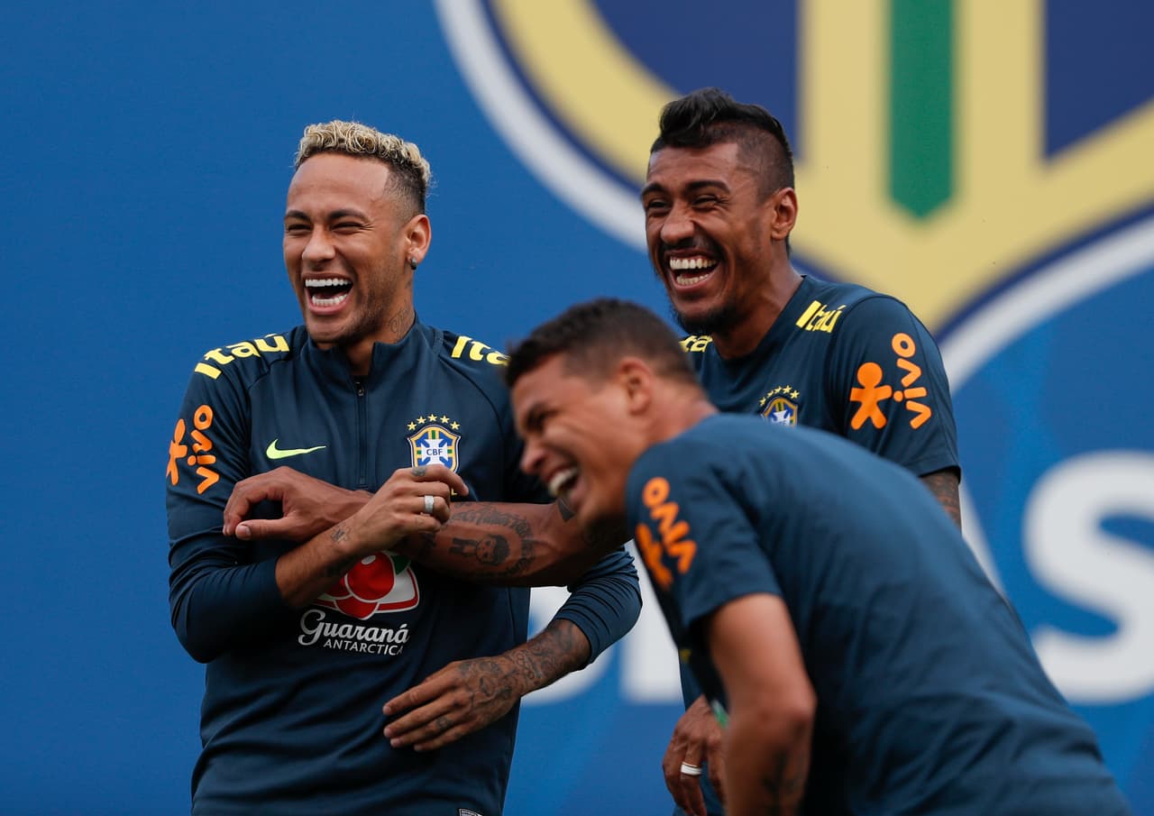 Brazil's forward Neymar (L) joke with team mates Brazil's defender Thiago Silva (C) and Brazil's midfielder Paulinho (R) during a training session of Brazil national football team at Yug Sport Stadium, in Sochi, on June 19, 2018, ahead of the Russia 2018 World Cup football tournament. (Photo by Adrian DENNIS / AFP) (Photo credit should read ADRIAN DENNIS/AFP/Getty Images)