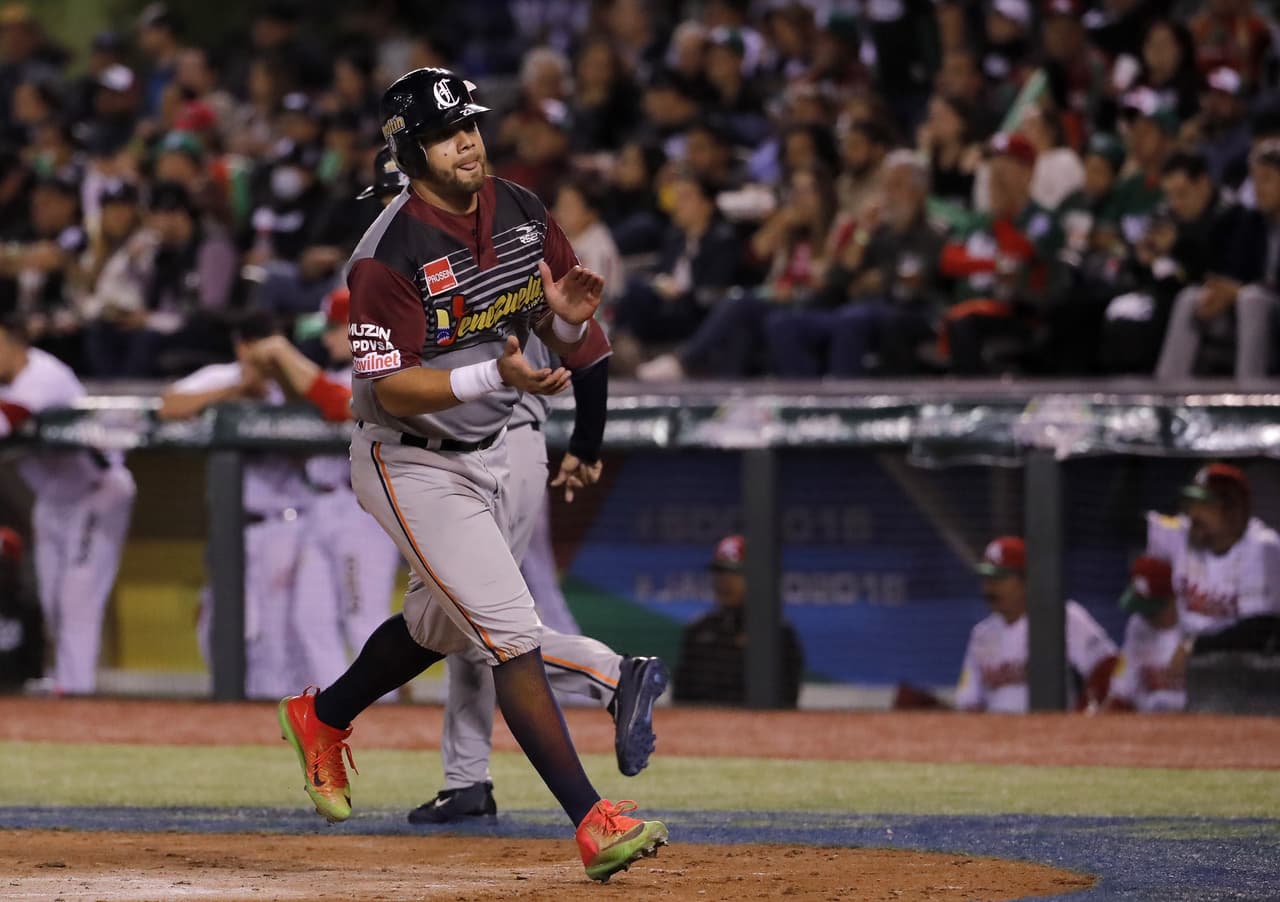 Luis Domoromo Caribes de Anzoategui of Venezuela celebrates after scoring against Tomateros de Culiacan of Mexico during the Caribbean Baseball Series at the Charros Jalisco stadium in Guadalajara, Jalisco state, Mexico, on February 4, 2018. / AFP PHOTO / ULISES RUIZ (Photo credit should read ULISES RUIZ/AFP/Getty Images)