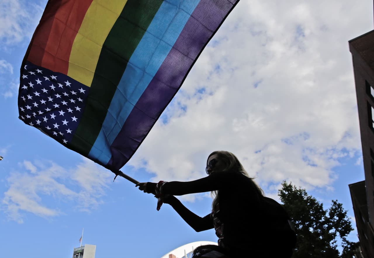 Una seguidora de la selección de Estados Unidos llega al estadio con una bandera de la comunidad LGBT para ver el juego de cuartos de final contra Ecuador, en Seattle.