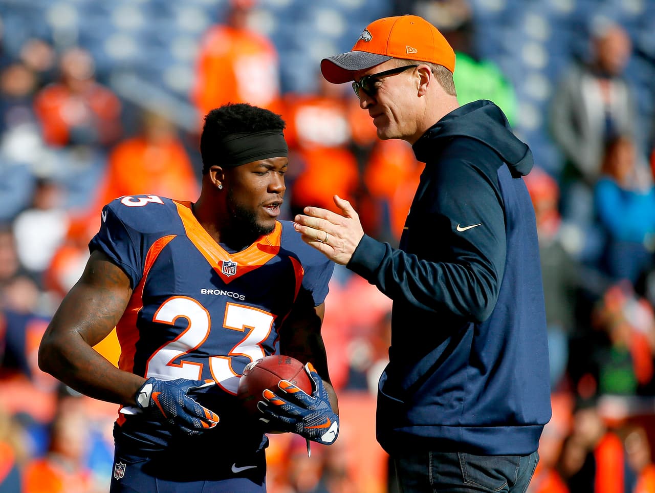 Denver Broncos injured quarterback Peyton Manning greets running back Ronnie Hillman (23) during warm ups prior to an NFL football game against the Oakland Raiders, Sunday, Dec. 13, 2015, in Denver. (AP Photo/Jack Dempsey)