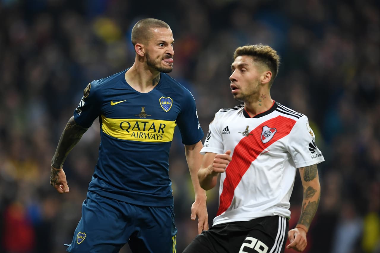 MADRID, SPAIN - DECEMBER 09: Dario Benedetto of Boca Juniors pulls a face at Gonzalo Montiel of River Plate as he celebrates after scoring his team's first goal during the second leg of the final match of Copa CONMEBOL Libertadores 2018 between Boca Juniors and River Plate at Estadio Santiago Bernabeu on December 9, 2018 in Madrid, Spain. Due to the violent episodes of November 24th at River Plate stadium, CONMEBOL rescheduled the game and moved it out of Americas for the first time in history. (Photo by Matthias Hangst/Getty Images)