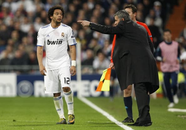 MADRID, SPAIN - MARCH 16: Head coach Jose Mourinho (R) of Real Madrid gives instructions to Marcelo Vieira during the UEFA Champions League round of 16 second leg match between Real Madrid and Lyon at Estadio Santiago Bernabeu on March 16, 2011 in Madrid, Spain. (Photo by Helios de la Rubia/Real Madrid via Getty Images)
