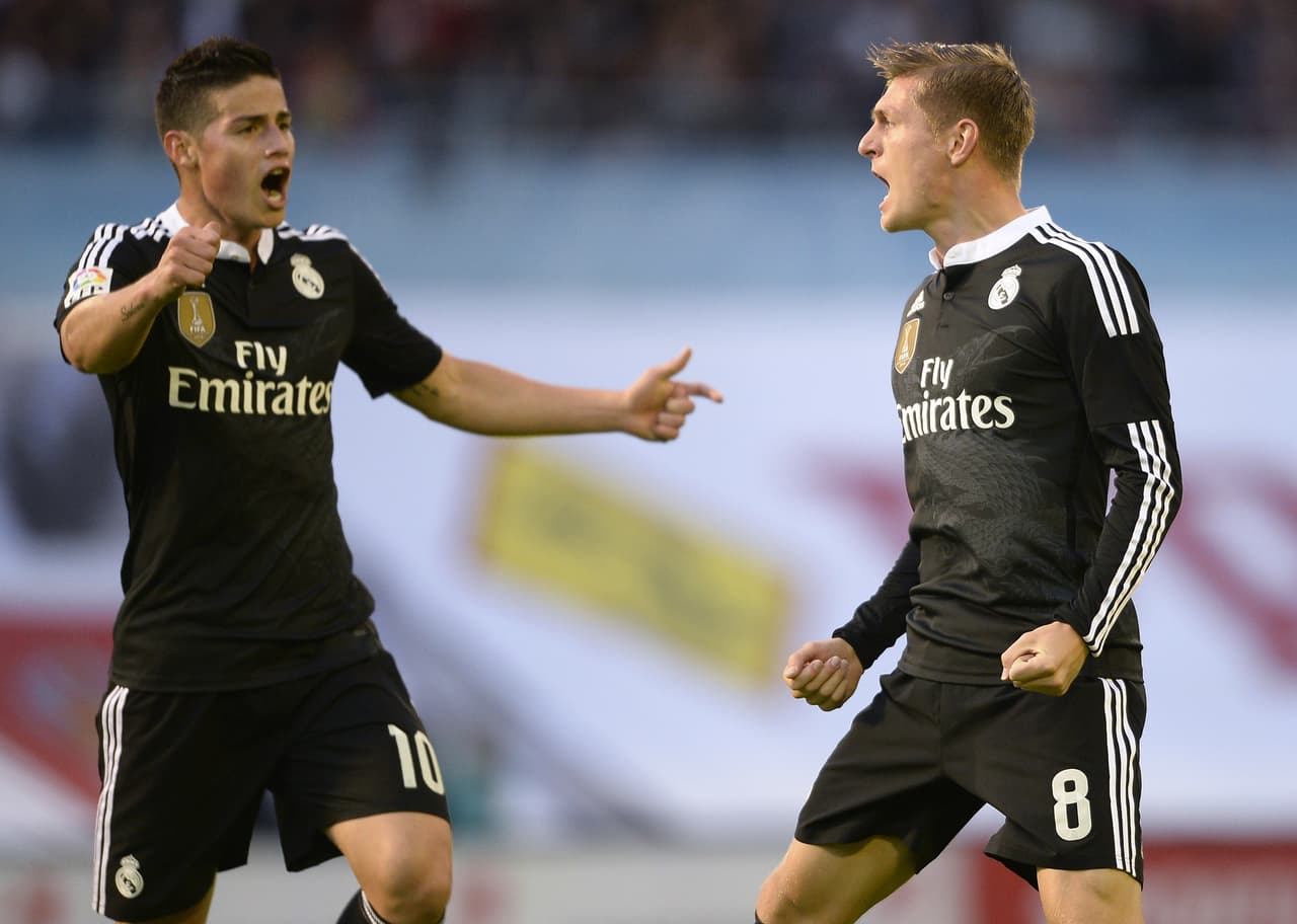 Real Madrid's German midfielder Toni Kroos (R) celebrates with teammate Colombian midfielder James Rodriguez after scoring a goal during the Spanish league football match Celta Vigo vs Real Madrid CF at the Balaidos stadium in Vigo on April 26, 2015. AFP PHOTO/ MIGUEL RIOPA (Photo credit should read MIGUEL RIOPA/AFP/Getty Images)