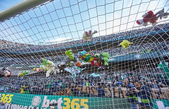 SEVILLE, SPAIN - DECEMBER 22: Real Betis fans throw stuffed animals to be collected and given to children in need during the La Liga match between Real Betis Balompie and SD Eibar at Estadio Benito Villamarin on December 22, 2018 in Seville, Spain. (Photo by Quality Sport Images/Getty Images)