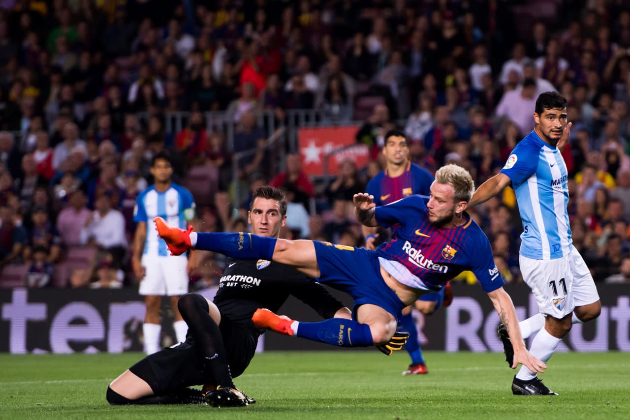 BARCELONA, SPAIN - OCTOBER 21: Ivan Rakitic of FC Barcelona collides with goalkeeper Andres Prieto of Malaga CF during the La Liga match between Barcelona and Malaga at Camp Nou on October 21, 2017 in Barcelona, Spain. (Photo by Alex Caparros/Getty Images)