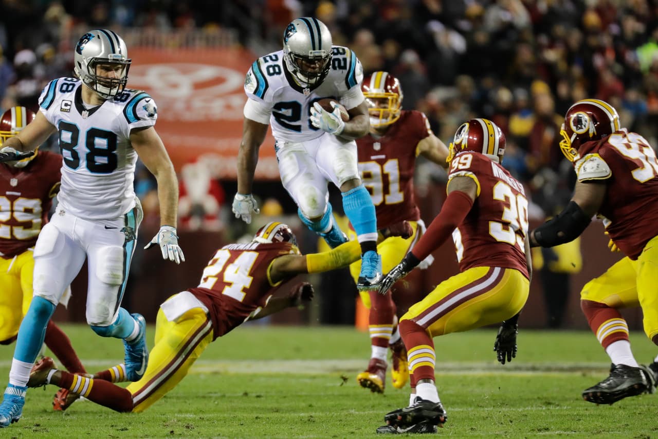 Carolina Panthers running back Jonathan Stewart (28) leaps over Washington Redskins cornerback Josh Norman (24) and safety Donte Whitner (39) during the first half of an NFL football game in Landover, Md., Monday, Dec. 19, 2016. (AP Photo/Patrick Semansky)