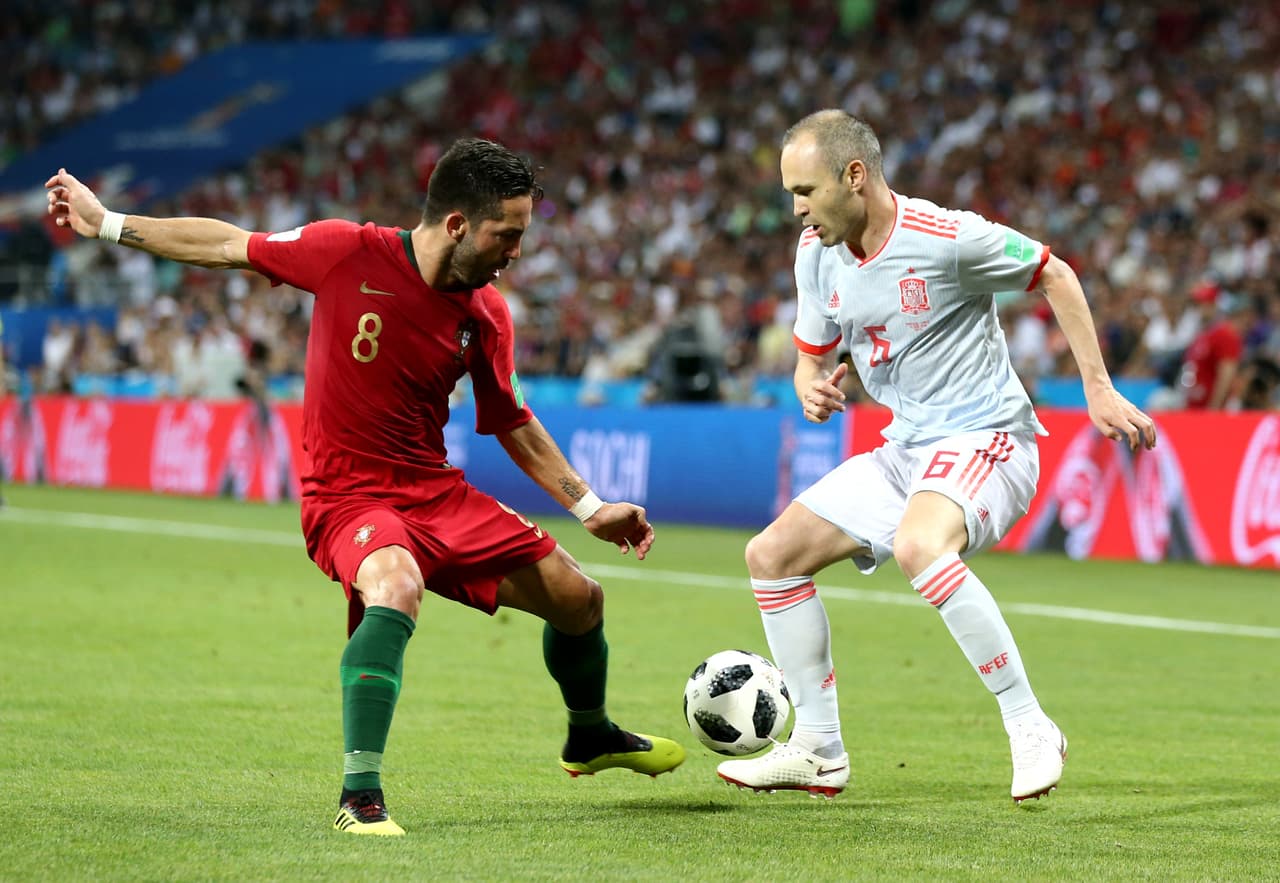 SOCHI, RUSSIA - JUNE 15: Andres Iniesta of Spain challenge for the ball with Joao Moutinho of Portugal during the 2018 FIFA World Cup Russia group B match between Portugal and Spain at Fisht Stadium on June 15, 2018 in Sochi, Russia. (Photo by Maddie Meyer/Getty Images)