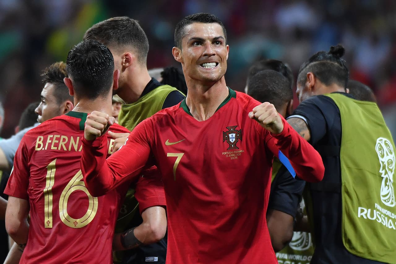 Portugal's forward Cristiano Ronaldo (C) celebrates his second goal with teammates during the Russia 2018 World Cup Group B football match between Portugal and Spain at the Fisht Stadium in Sochi on June 15, 2018. (Photo by Nelson Almeida / AFP) / RESTRICTED TO EDITORIAL USE - NO MOBILE PUSH ALERTS/DOWNLOADS (Photo credit should read NELSON ALMEIDA/AFP/Getty Images)