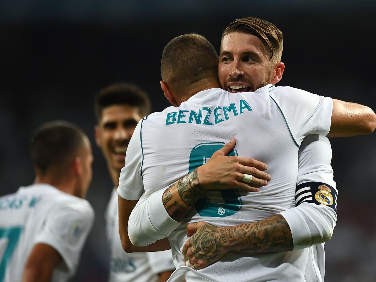 Real Madrid's French forward Karim Benzema (front) celebrates with Real Madrid's defender Sergio Ramos after scoring their second goal during the second leg of the Spanish Supercup football match Real Madrid vs FC Barcelona at the Santiago Bernabeu stadium in Madrid, on August 16, 2017. / AFP PHOTO / GABRIEL BOUYS (Photo credit should read GABRIEL BOUYS/AFP/Getty Images)