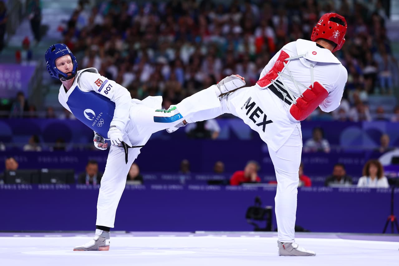PARIS, FRANCE - AUGUST 10: Carlos Sansores of Team Mexico (red) and Nikita Rafalovich of Team Uzbekistan (blue) compete during the Men's +80kg Repechage on day fifteen of the Olympic Games Paris 2024 at Grand Palais on August 10, 2024 in Paris, France. (Photo by Buda Mendes/Getty Images)