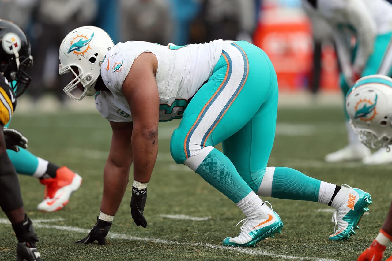Miami Dolphins defensive tackle Ndamukong Suh (93) gets set to rush from a three point stance during the 2016 NFL season AFC Wild Card playoff football game against the Pittsburgh Steelers on Sunday, Jan. 8, 2017 in Pittsburgh. The Steelers won the game 30-12. (Paul Spinelli via AP)