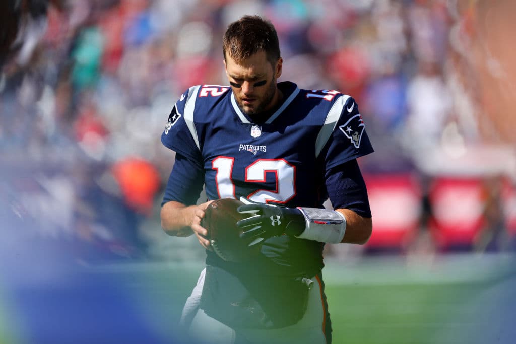 FOXBOROUGH, MA - SEPTEMBER 30: Tom Brady #12 of the New England Patriots stands with the football on the sideline before the game against the Miami Dolphins at Gillette Stadium on September 30, 2018 in Foxborough, Massachusetts. (Photo by Maddie Meyer/Getty Images)