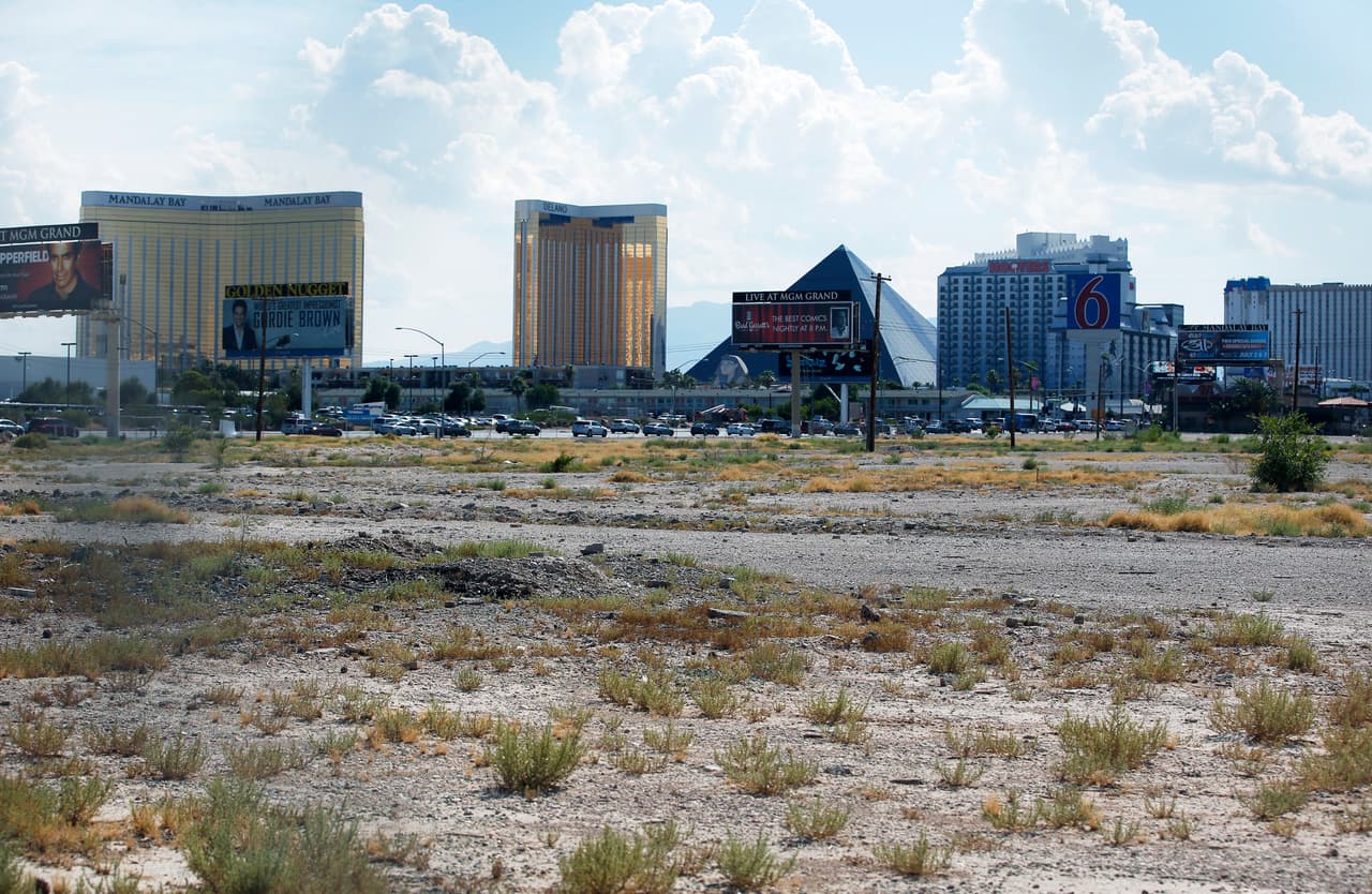 FILE - In this July 1, 2016, file photo, a vacant lot that is the site of a proposed football stadium sits near McCarran International Airport in Las Vegas. Nevada lawmakers convene Monday, Oct. 10, 2016, to consider raising taxes in the Las Vegas area to help fund a $1.9 billion football stadium, a $1.4 billion convention center expansion and more police officers to protect the additional tourists. (AP Photo/John Locher, File)