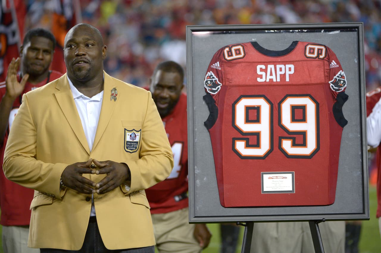 Former Tampa Bay Buccaneers defensive lineman Warren Sapp watches as he is inducted into the team's Ring of Honor during a halftime ceremony of an NFL football game against the Miami Dolphins in Tampa, Fla., Monday, Nov. 11, 2013. (AP Photo/Phelan M. Ebenhack)