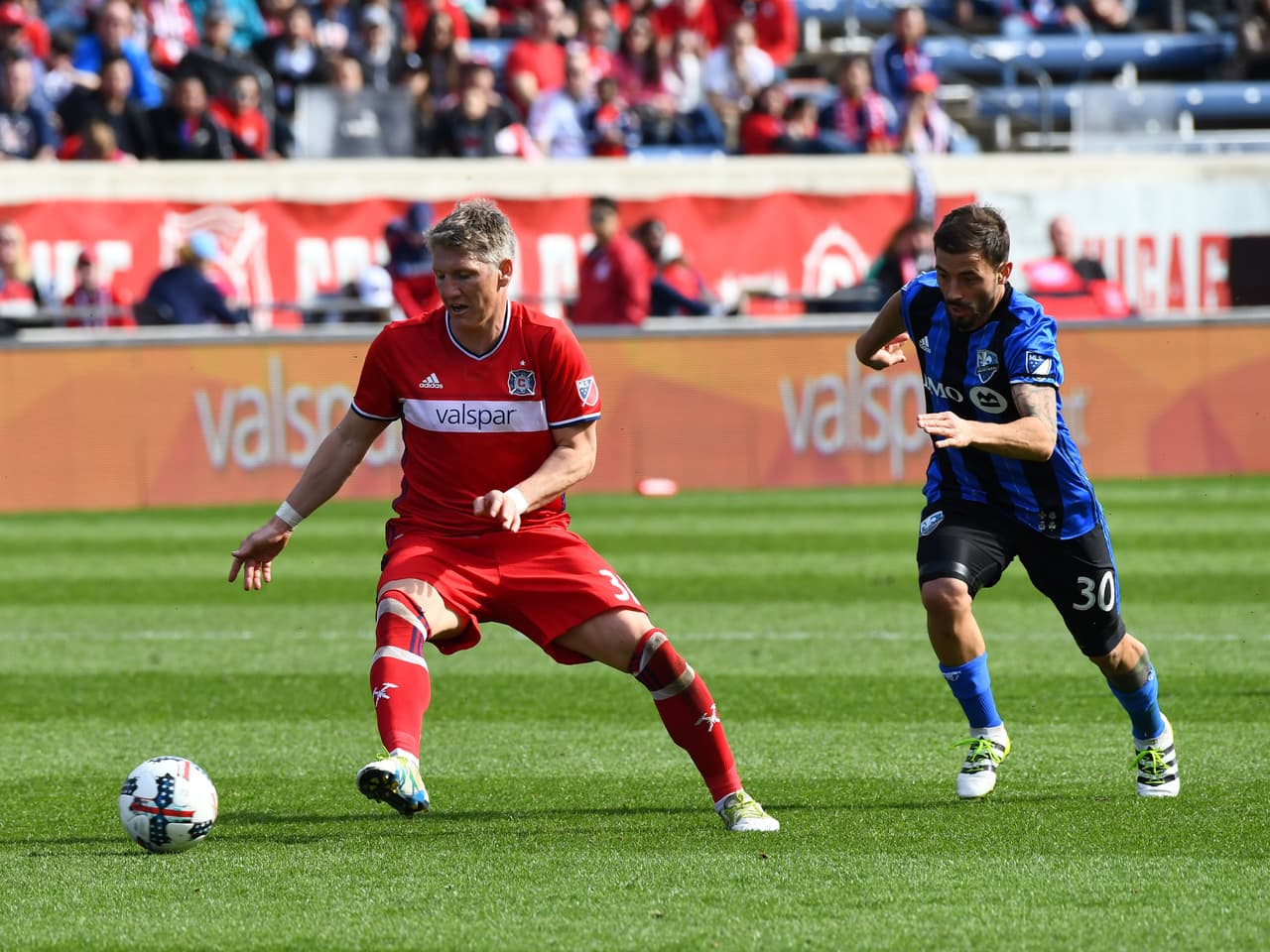Apr 1, 2017; Chicago, IL, USA; Chicago Fire midfielder Bastian Schweinsteiger (31) kicks the ball past Montreal Impact midfielder Hernan Bernardello (30) during the second half at Toyota Park. The Chicago Fire and Montreal Impact game ends in a draw 2-2. Mandatory Credit: Mike DiNovo-USA TODAY Sports