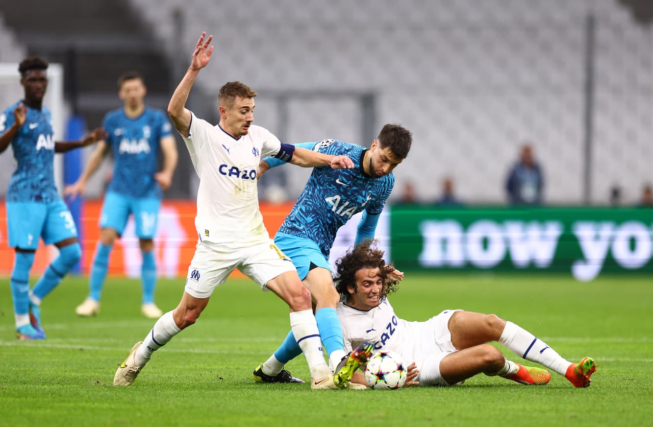 MARSEILLE, FRANCE - NOVEMBER 01: Rodrigo Bentancur of Tottenham Hotspur is challenged by Matteo Guendouzi and Valentin Rongier of Marseille during the UEFA Champions League group D match between Olympique Marseille and Tottenham Hotspur at Orange Velodrome on November 01, 2022 in Marseille, France. (Photo by Clive Rose/Getty Images)