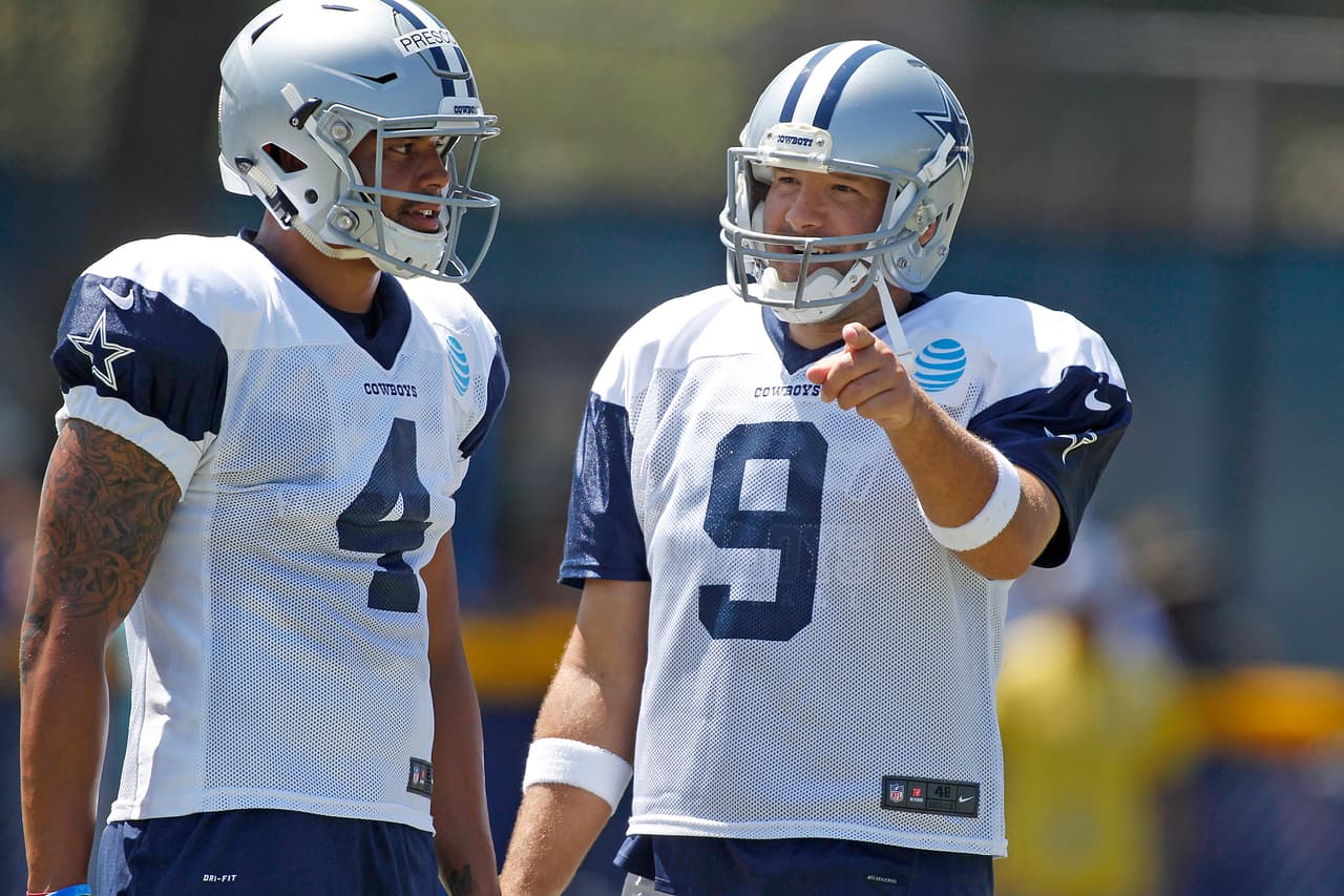 Dallas Cowboys quarterbacks Tony Romo (9) and Dak Prescott (4) talk during an NFL training camp Thursday, August 11, 2016 at City of Oxnard Fields in Oxnard, California. (James D Smith via AP)