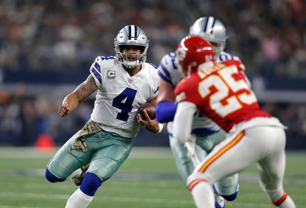 Dallas Cowboys' Dak Prescott (4) runs the ball as Kansas City Chiefs' Kenneth Acker (25) gives chase in the second half of an NFL football game, Sunday, Nov. 5, 2017, in Arlington, Texas. (AP Photo/Brandon Wade)