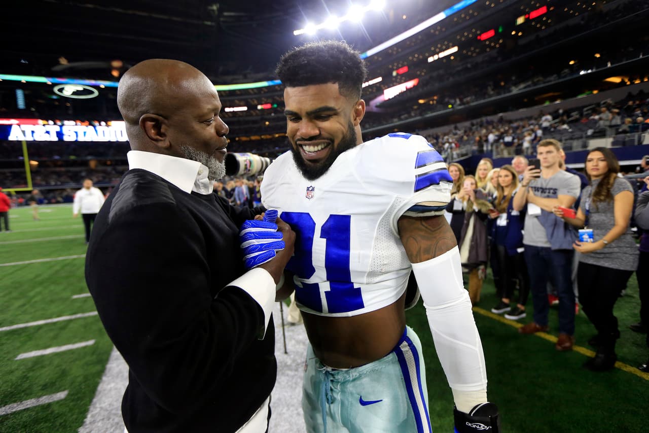 Hall of Fame running back Emmitt Smith, left, talks with Dallas Cowboys running back Ezekiel Elliott (21) during warm ups before an NFL football game against the Tampa Bay Buccaneers on Sunday, Dec. 18, 2016, in Arlington, Texas. (AP Photo/Ron Jenkins)