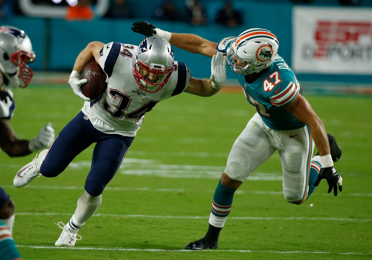 Miami Dolphins middle linebacker Kiko Alonso (47) attempts to tackle New England Patriots running back Rex Burkhead (34), during the first half of an NFL football game, Monday, Dec. 11, 2017, in Miami Gardens, Fla. (AP Photo/Wilfredo Lee)