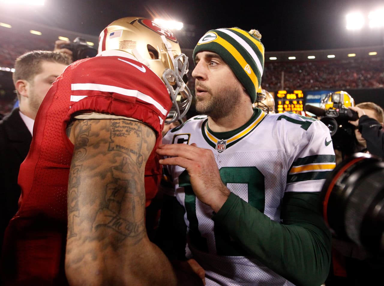 Green Bay Packers quarterback Aaron Rodgers (12), facing, speaks to San Francisco 49ers quarterback Colin Kaepernick (7) after an NFC divisional playoff NFL football game in San Francisco, Saturday, Jan. 12, 2013. The 49ers won 45-31. (AP Photo/Tony Avelar)