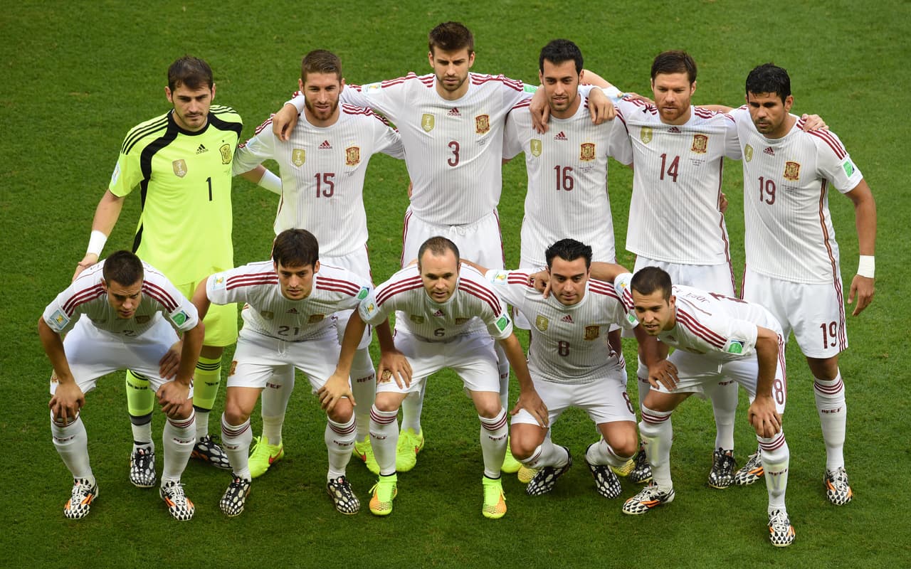 (FromL) Spain's goalkeeper Iker Casillas, Spain's defender Sergio Ramos, Spain's defender Gerard Pique, Spain's midfielder Sergio Busquets, Spain's midfielder Xabi Alonso and Spain's forward Diego Costa (down) Spain's defender Cesar Azpilicueta, Spain's midfielder David Silva, Spain's midfielder Andres Iniesta, Spain's midfielder Xavi and Spain's defender Jordi Alba pose before the Group B football match between Spain and the Netherlands at the Fonte Nova Arena in Salvador during the 2014 FIFA World Cup on June 13, 2014. AFP PHOTO / DIMITAR DILKOFF (Photo credit should read DIMITAR DILKOFF/AFP/Getty Images)